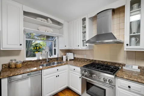 a living room with furniture a clock and a flat screen tv