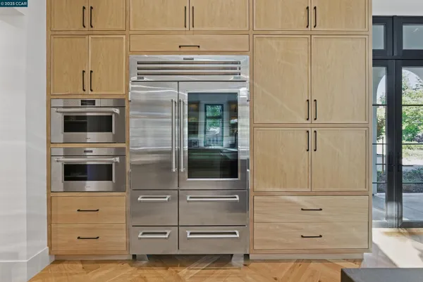a spacious bathroom with a double vanity sink a large mirror and bathtub
