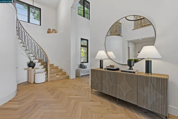 a view of a living room with furniture and wooden floor