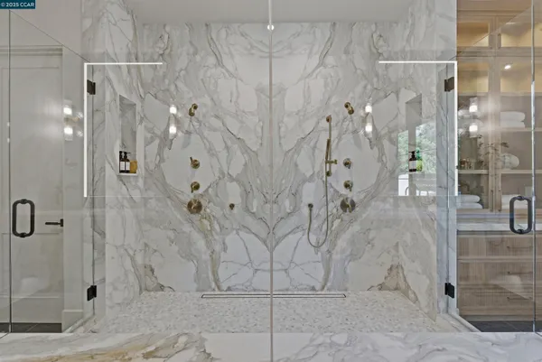 a view of staircase with railing and white walls