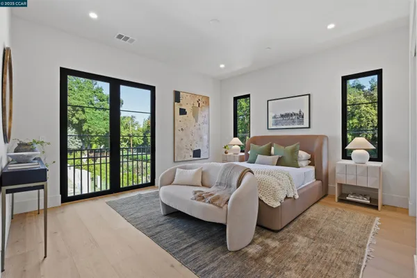 a living room with furniture a window and a potted plant