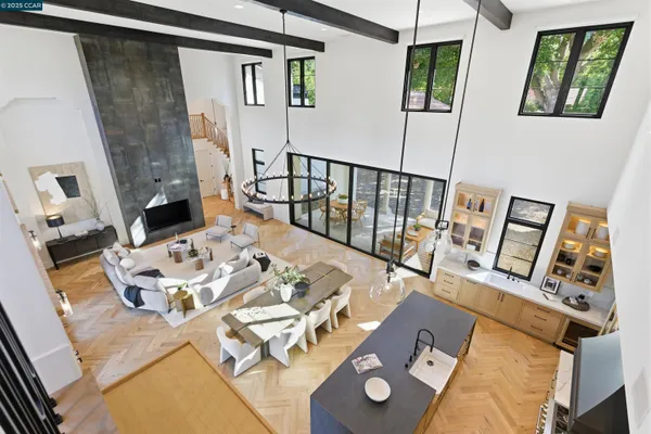 a living room with furniture kitchen and a chandelier