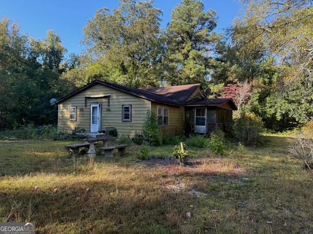 a view of house with outdoor seating