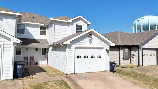a front view of a house with backyard