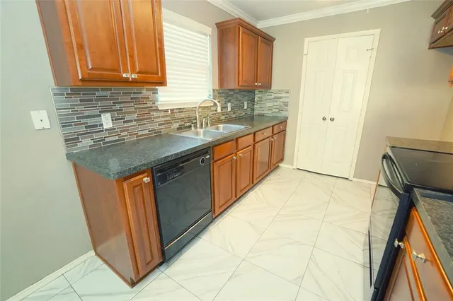 a kitchen with stainless steel appliances granite countertop a sink stove and cabinets