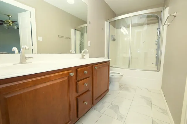 a spacious bathroom with a mirror a shower and a sink