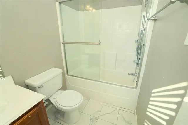 a white toilet sitting next to a bathroom sink