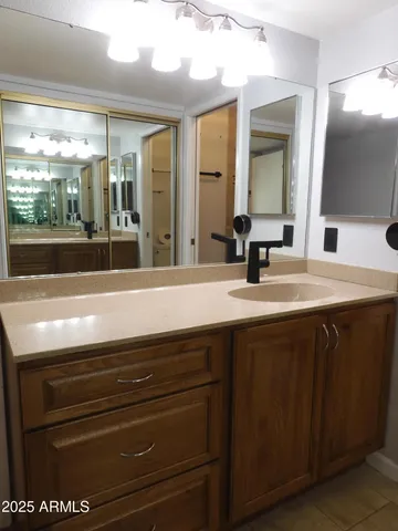 a bathroom with a sink a vanity and mirror