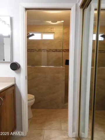 a bathroom with a toilet and a shower