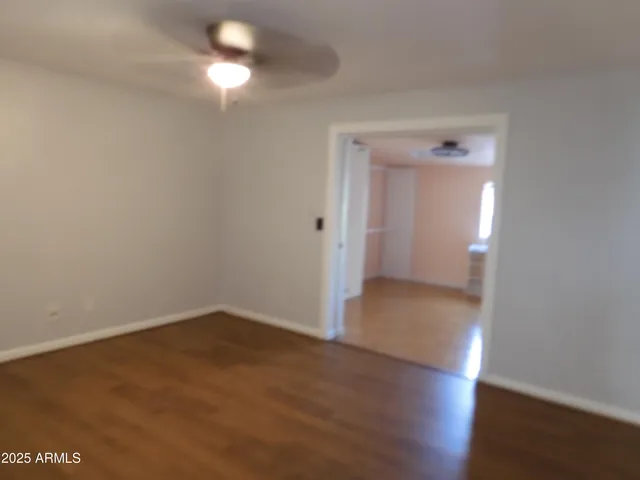 a view of a room with wooden floor and windows