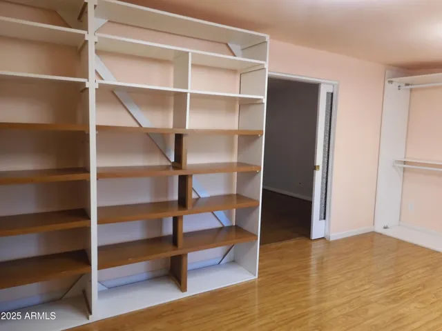 a view of room with wooden floor and closet