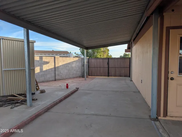 a view of a patio with a table chairs and a patio