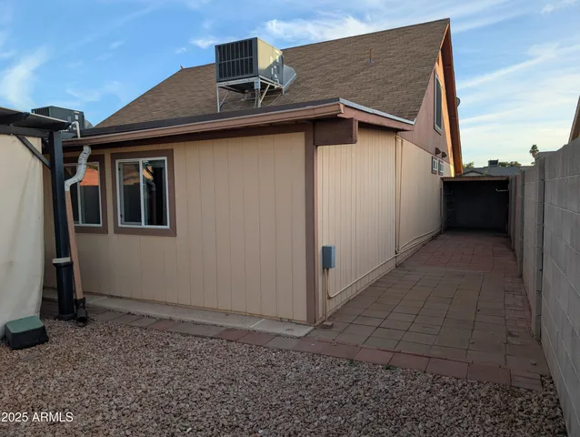 a view of a backyard with table and chairs and a barbeque