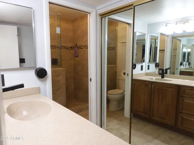 a en suite bathroom with a sink a toilet and shower