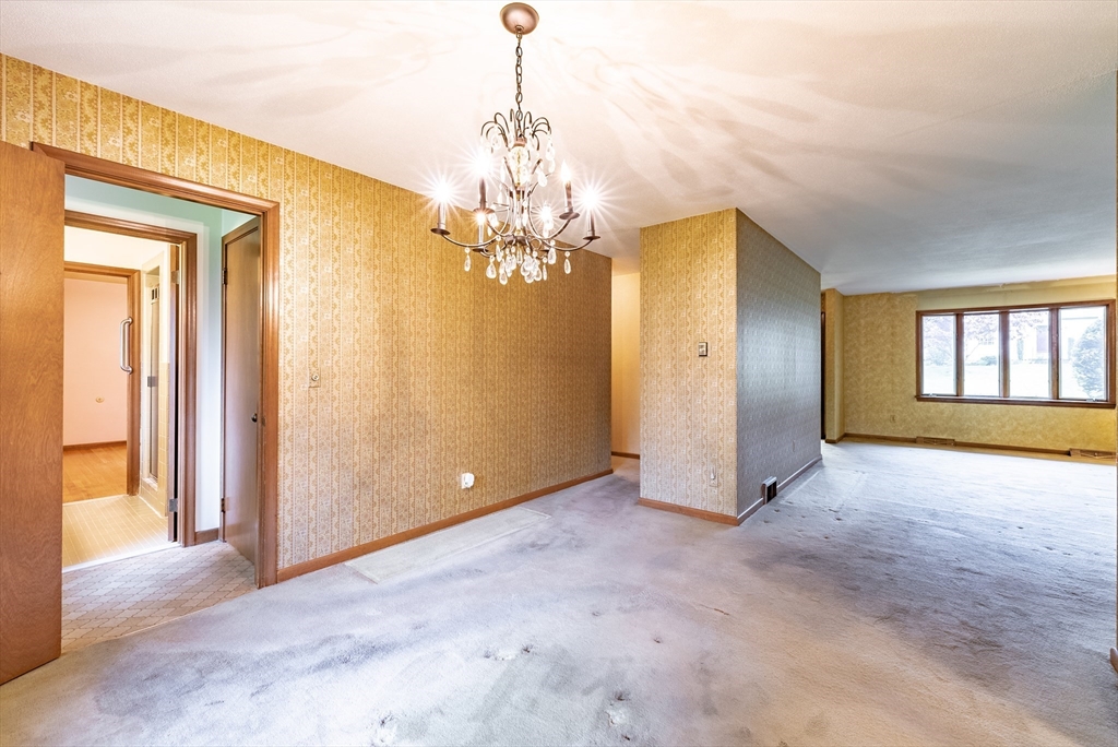 122 Benz Street Springfield, MA 01118 - Photo 15 of 28 a view of a big room with windows and chandelier