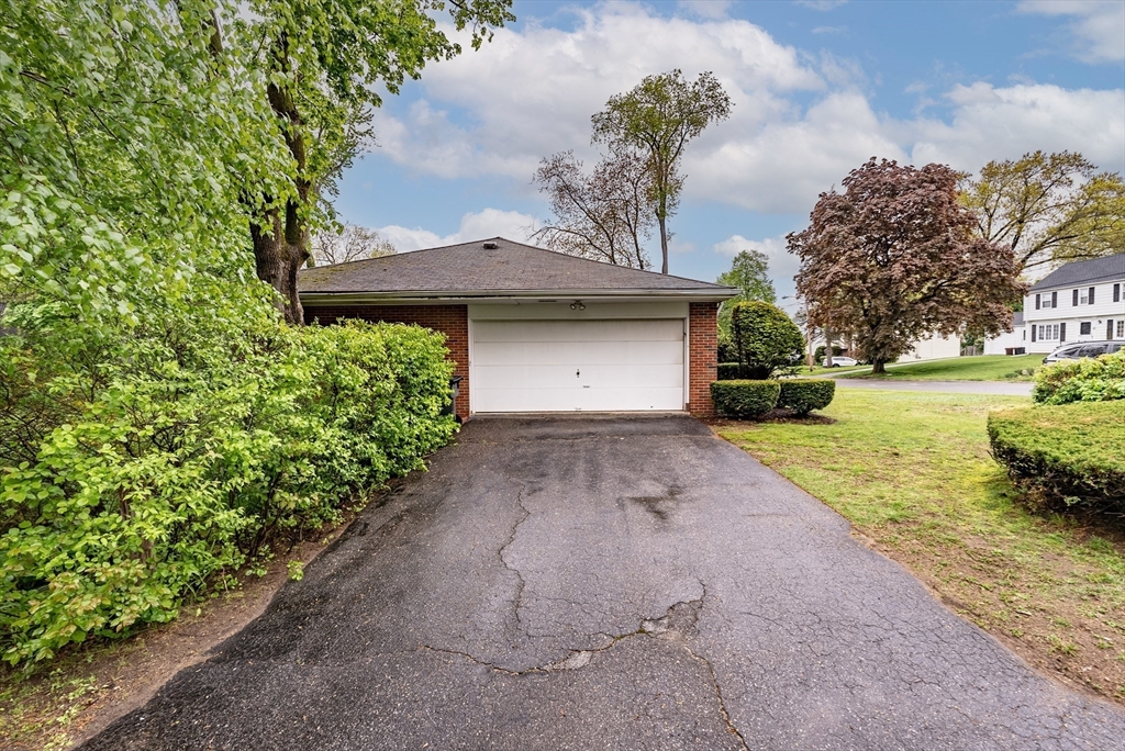 122 Benz Street Springfield, MA 01118 - Photo 26 of 28 a front view of a house with a yard and garage