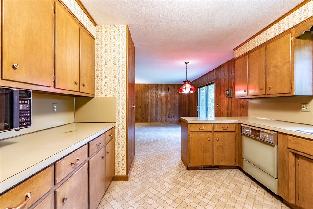 122 Benz Street Springfield, MA 01118 - Photo 4 of 28 a kitchen with stainless steel appliances granite countertop a sink and cabinets with wooden floor