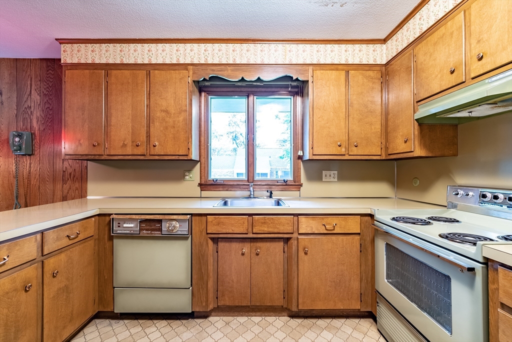 122 Benz Street Springfield, MA 01118 - Photo 5 of 28 a kitchen with a sink stove and cabinets