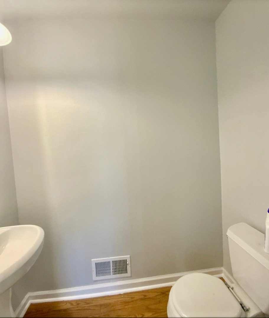 3929 Pinecrest Road Rockford, IL 61107 - Photo 23 of 33 a white toilet sitting next to a white sink and vanity