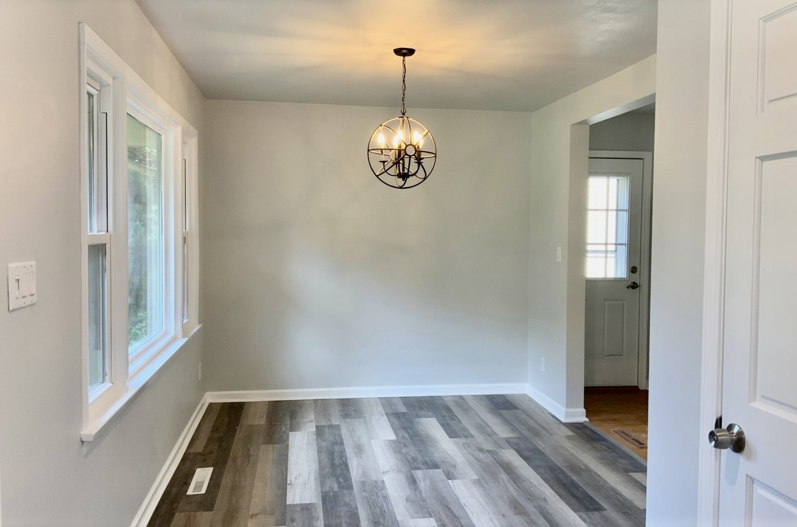 3929 Pinecrest Road Rockford, IL 61107 - Photo 8 of 33 a view of an empty room with wooden floor and a window