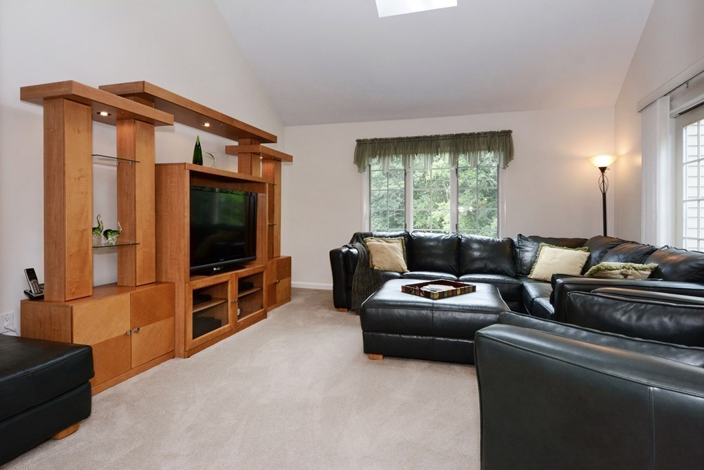 52 Powder Hill Way, Unit 52 Westborough, MA 01581 - Photo 14 of 38 a living room with furniture and a flat screen tv