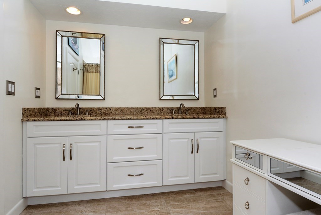 52 Powder Hill Way, Unit 52 Westborough, MA 01581 - Photo 19 of 38 a bathroom with a sink and a mirror