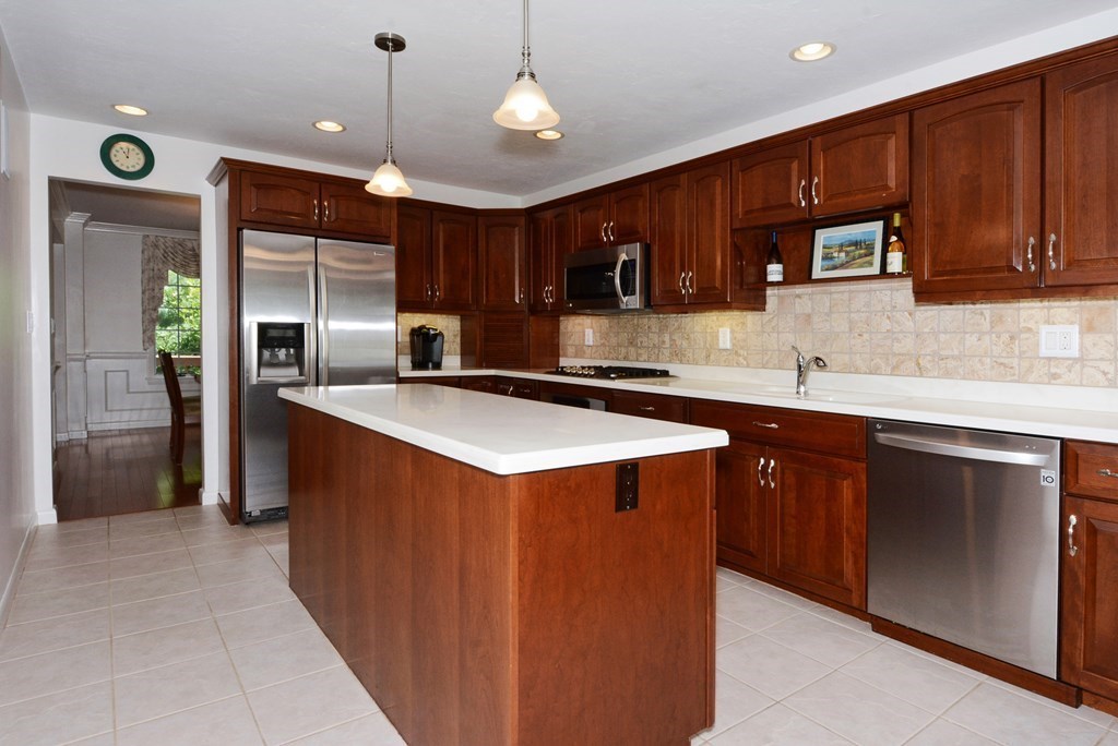 52 Powder Hill Way, Unit 52 Westborough, MA 01581 - Photo 2 of 38 a kitchen with stainless steel appliances granite countertop a sink a stove and a refrigerator