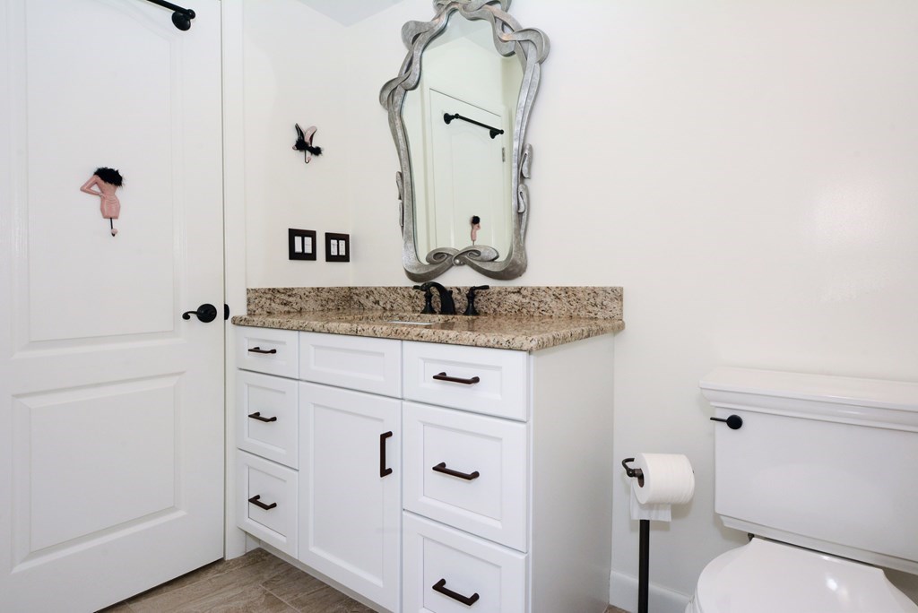 52 Powder Hill Way, Unit 52 Westborough, MA 01581 - Photo 23 of 38 a bathroom with a granite countertop sink mirror vanity and toilet