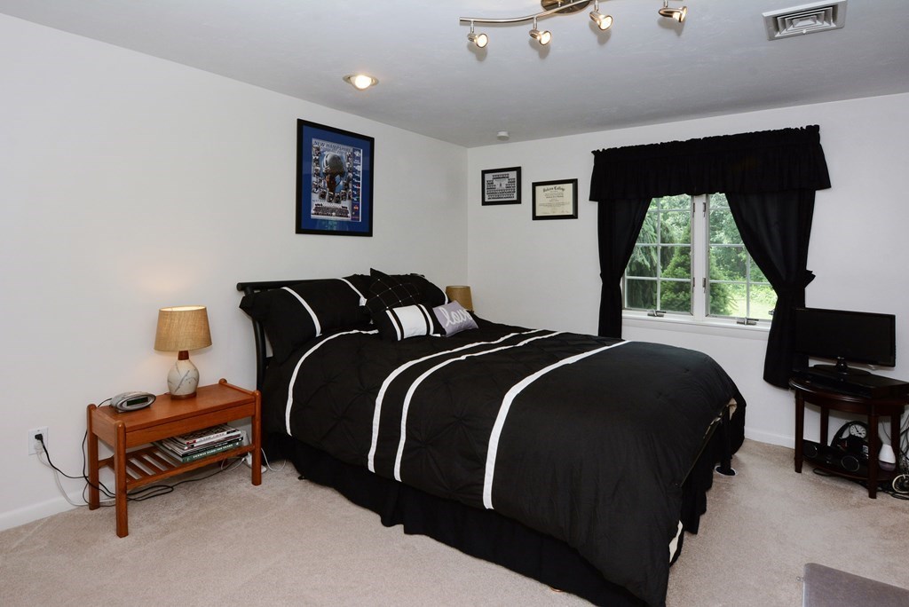 52 Powder Hill Way, Unit 52 Westborough, MA 01581 - Photo 25 of 38 a bedroom with a bed and window