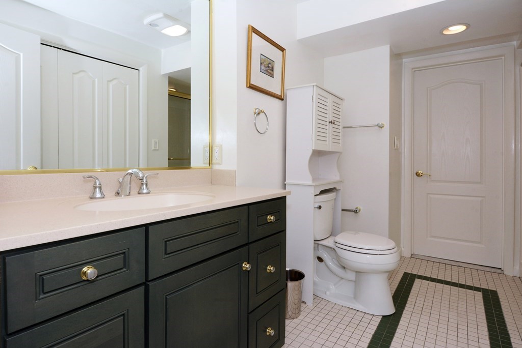 52 Powder Hill Way, Unit 52 Westborough, MA 01581 - Photo 29 of 38 a bathroom with a sink and a mirror