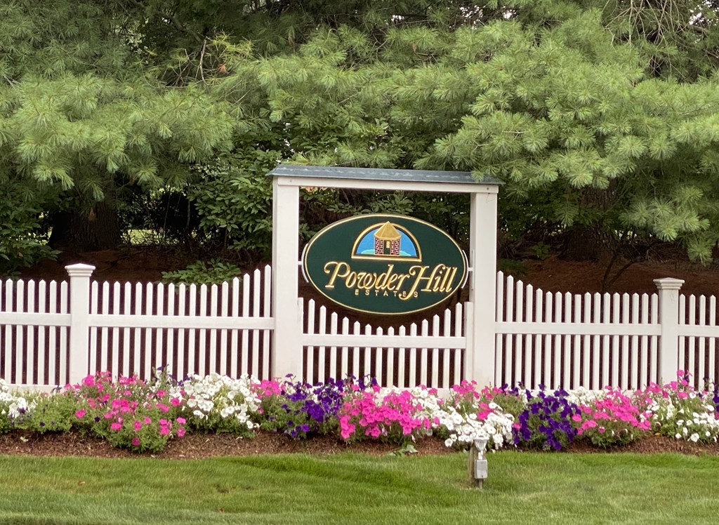 52 Powder Hill Way, Unit 52 Westborough, MA 01581 - Photo 35 of 38 a garden with flowers and wooden fence