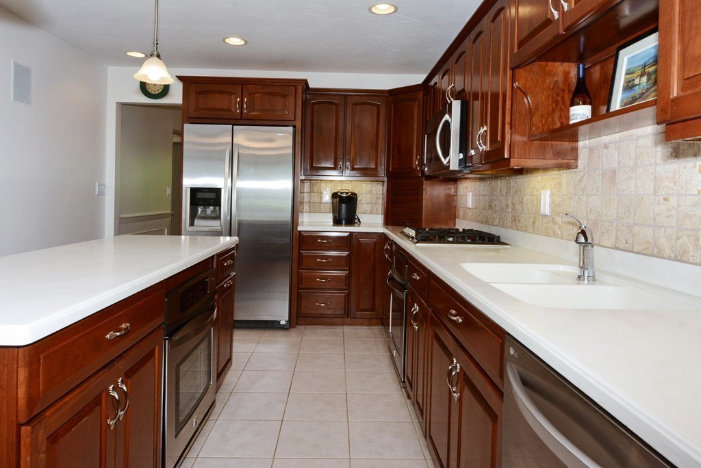 52 Powder Hill Way, Unit 52 Westborough, MA 01581 - Photo 5 of 38 a kitchen with stainless steel appliances granite countertop a sink and a refrigerator