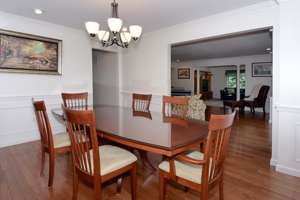 52 Powder Hill Way, Unit 52 Westborough, MA 01581 - Photo 9 of 38 a view of a dining room with furniture wooden floor and chandelier