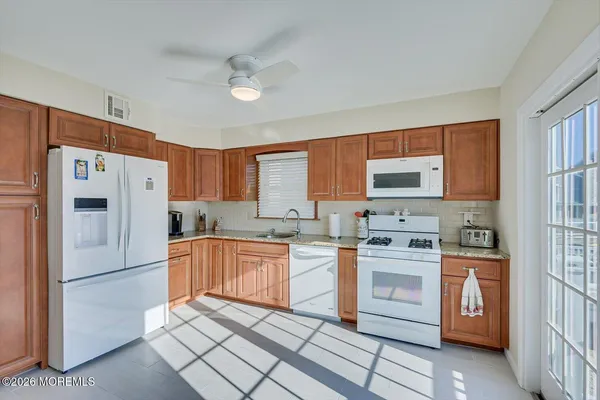 a spacious bedroom with a bed and wooden floor