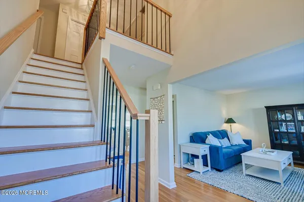a view of a balcony with wooden floor and furniture