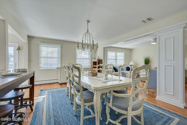 a spacious bedroom with a bed and a dresser