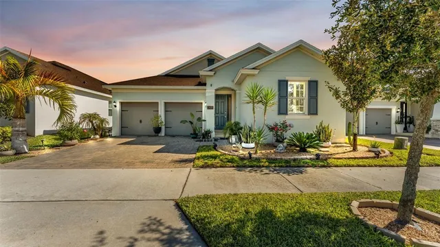 a view of a house with backyard and sitting area