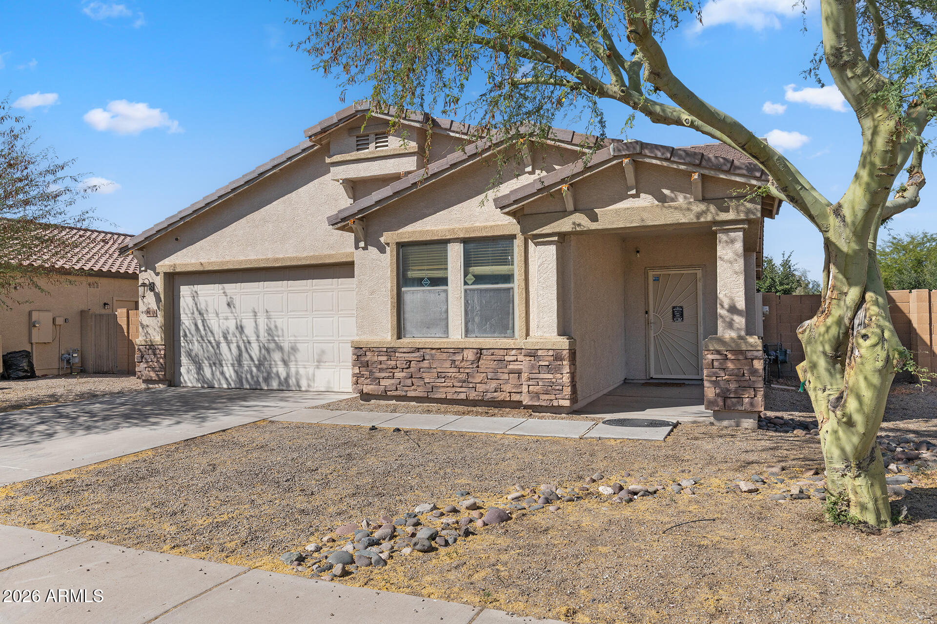 6718 West Darrel Road Laveen, AZ 85339 - Photo 6 of 49 a front view of a house with garden