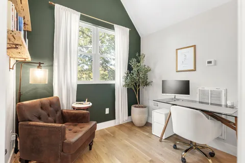 a work room with furniture and a potted plant