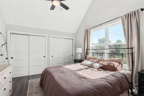 a bedroom with a large bed and a large window