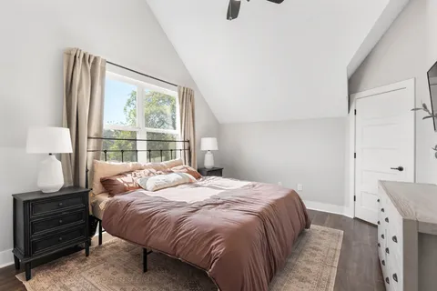 a bedroom with a bed and a window