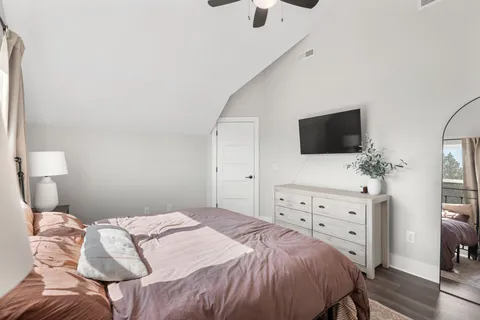 a bedroom with a bed and a flat screen tv