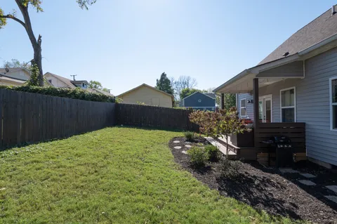 a view of a backyard with wooden fence