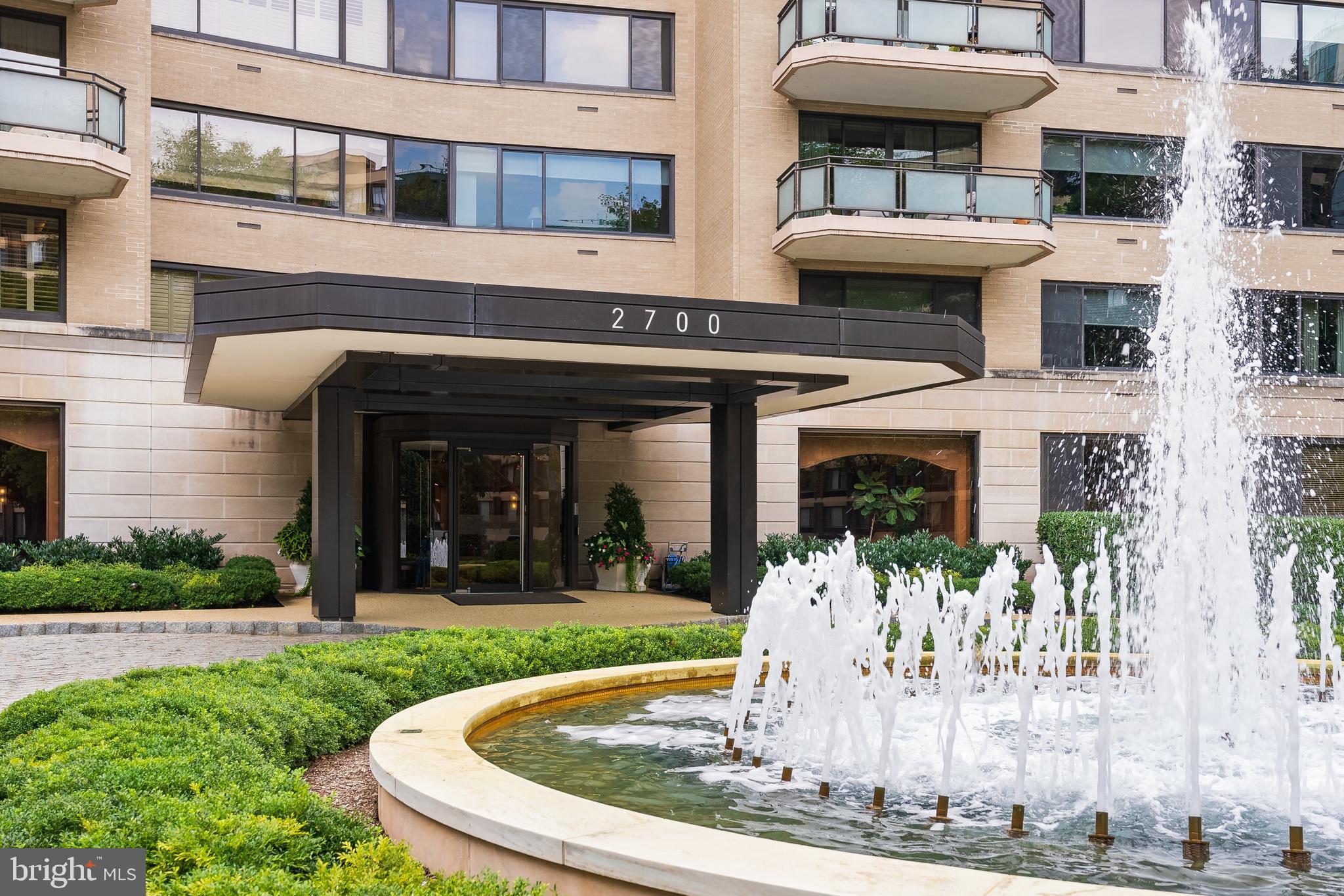 a front view of a building with a garden