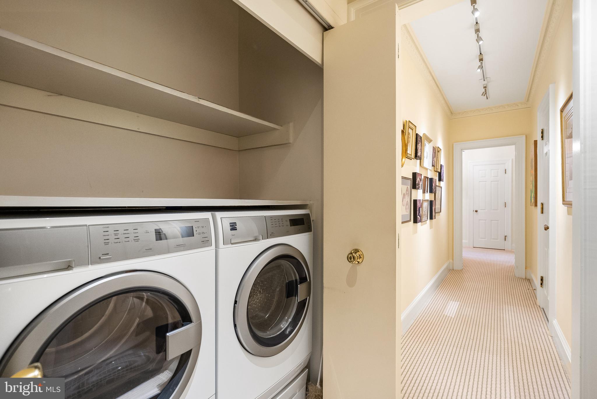 2700 Calvert Street Northwest, Unit 418 Washington, DC 20008 - Photo 21 of 28 a view of a hallway with washer and dryer