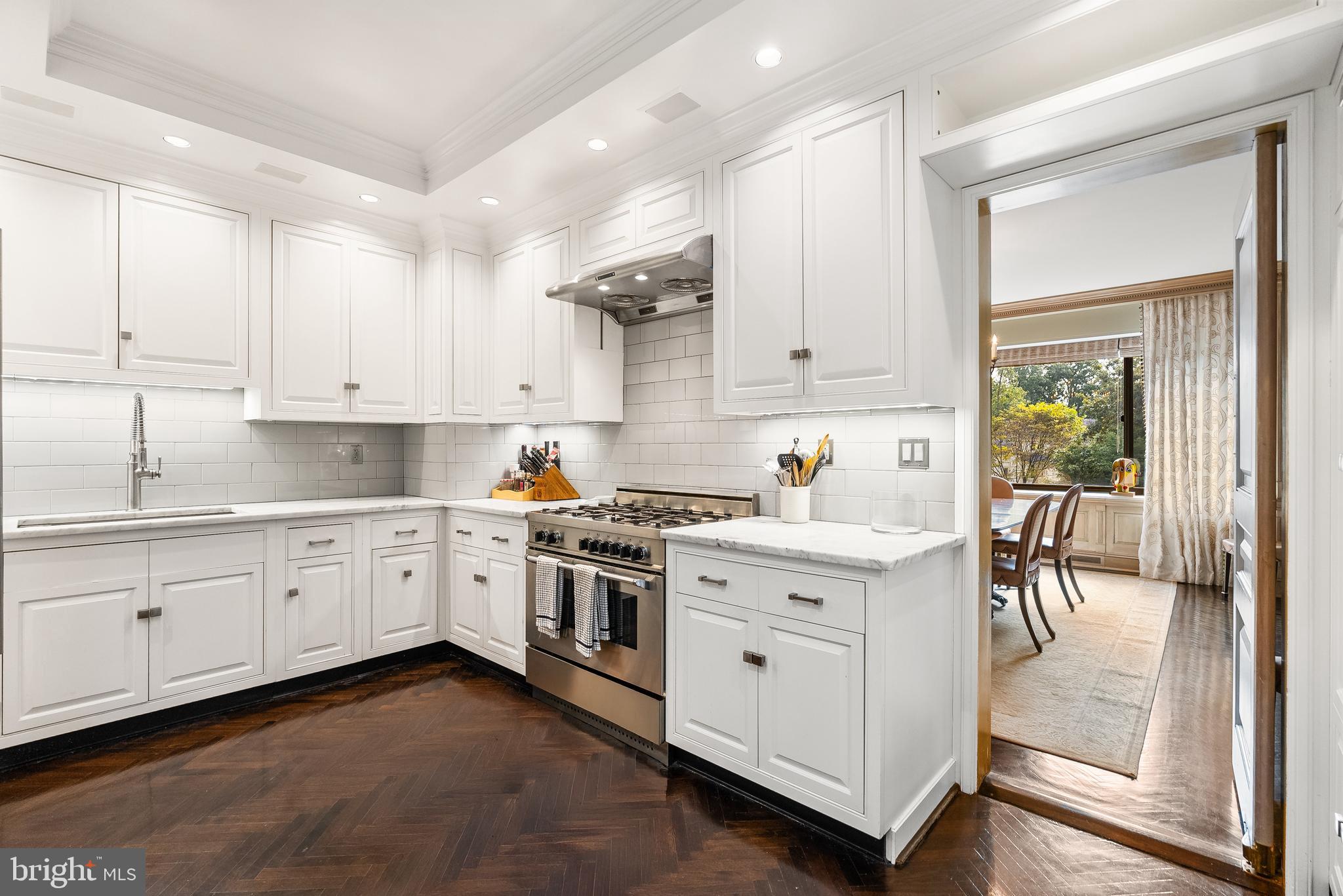 2700 Calvert Street Northwest, Unit 418 Washington, DC 20008 - Photo 8 of 28 a kitchen with granite countertop white cabinets and white appliances