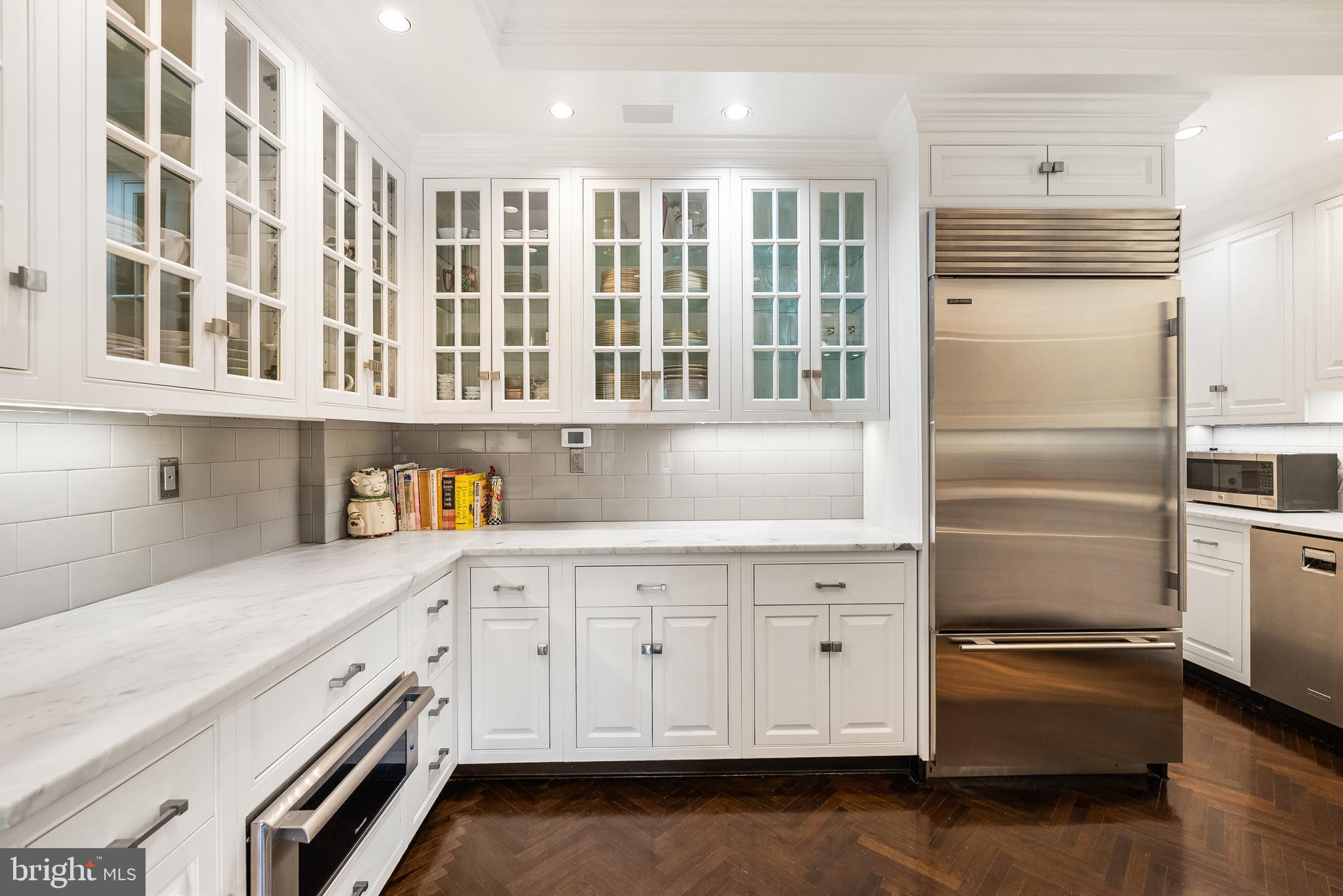 2700 Calvert Street Northwest, Unit 418 Washington, DC 20008 - Photo 10 of 28 a kitchen with granite countertop white cabinets and stainless steel appliances