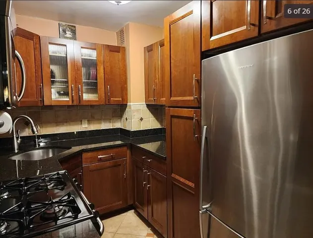 a kitchen with stainless steel appliances a refrigerator and a sink