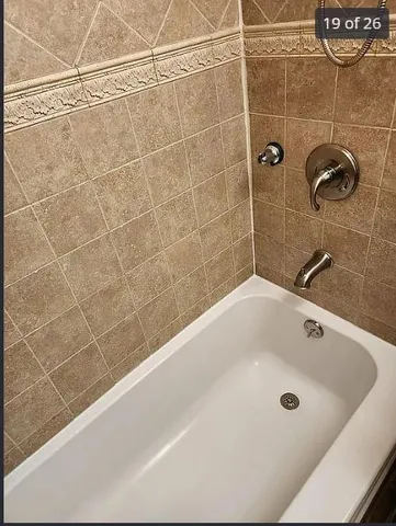 a bathroom with a bath tub and shower