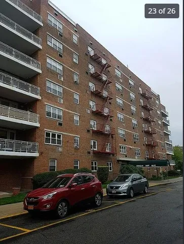 a couple of cars parked in front of a building